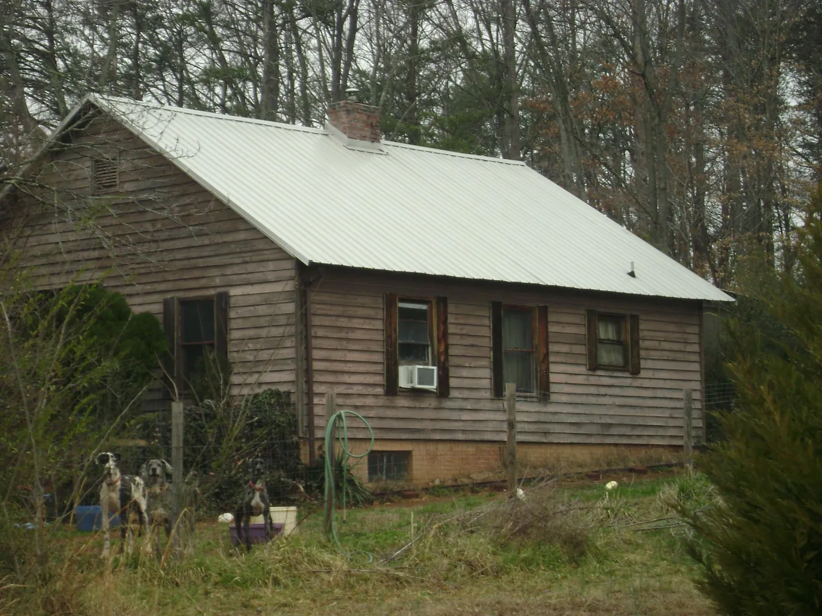 White metal roof on an old wood sided farmhouse, from a Metal Roof Installation job in Lafayette